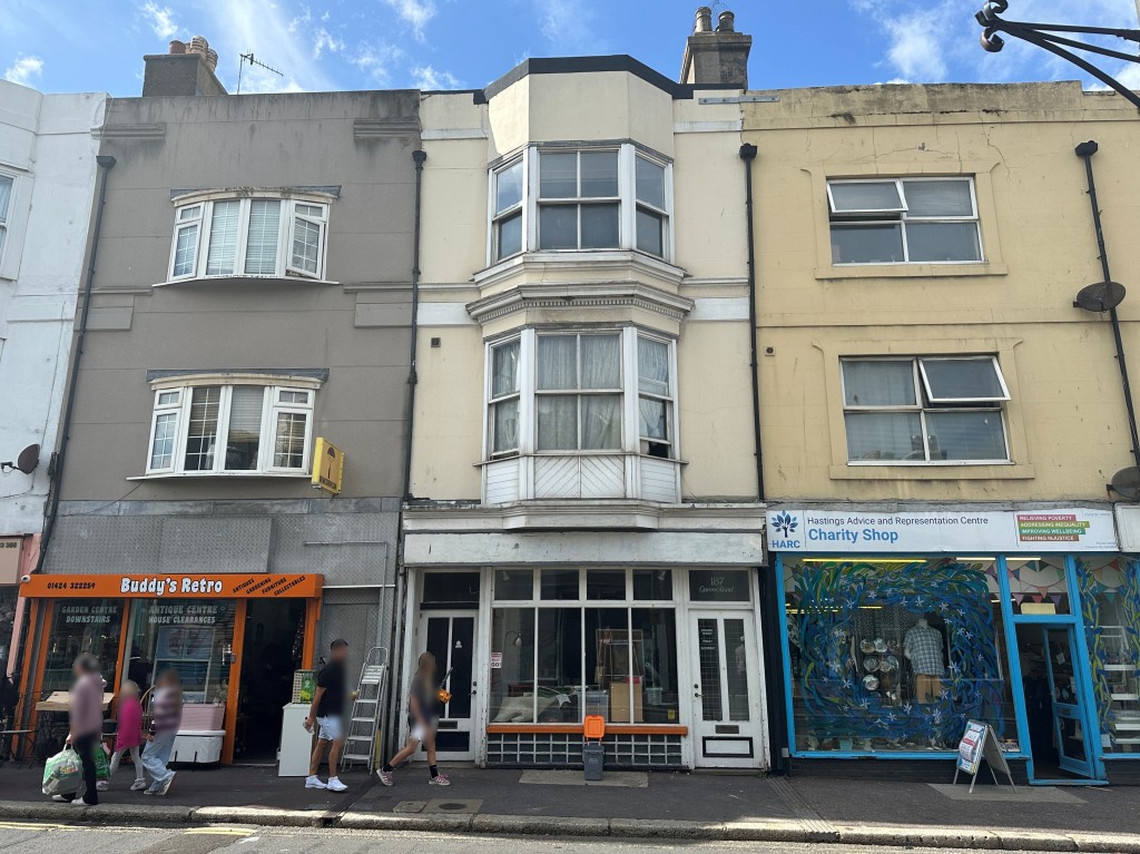 Lot: 44 - MIXED RESIDENTIAL AND COMMERCIAL BUILDING WITH POTENTIAL - Front of property showing glass shop front and bay windows on first and second floors